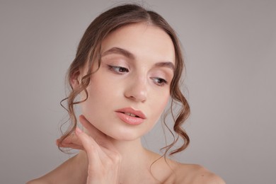 Photo of Portrait of attractive young woman on light grey background