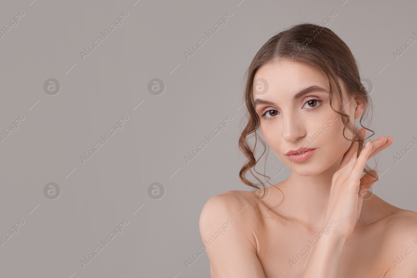 Photo of Portrait of attractive young woman on light grey background. Space for text