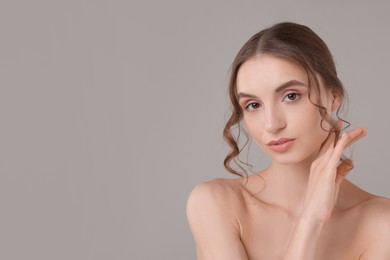 Photo of Portrait of attractive young woman on light grey background. Space for text