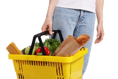 Photo of Woman with shopping basket full of products on white background, closeup