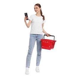 Photo of Woman with plastic shopping basket and smartphone on white background