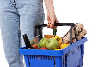 Photo of Woman with shopping basket full of products on white background, closeup