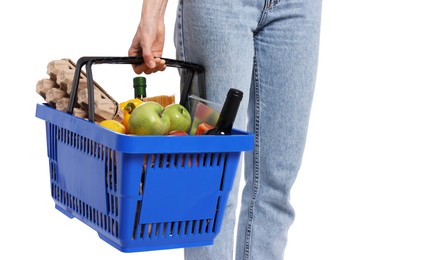 Photo of Woman with shopping basket full of products on white background, closeup