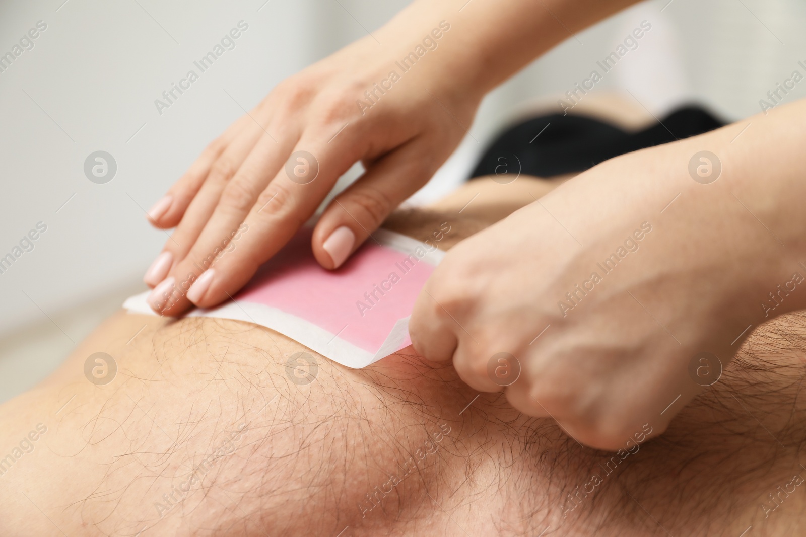 Young man undergoing wax epilation in salon, closeup Photo of Young man undergoing wax epilation in salon, closeup