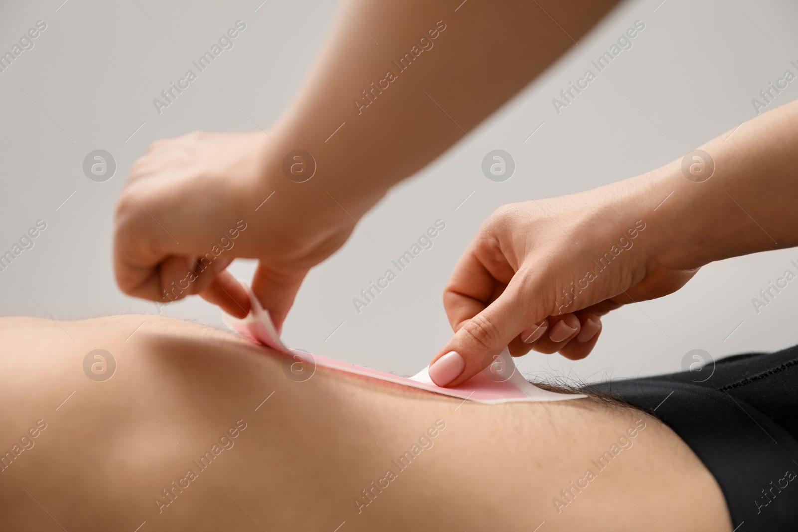 Young man undergoing wax epilation in salon, closeup Photo of Young man undergoing wax epilation in salon, closeup