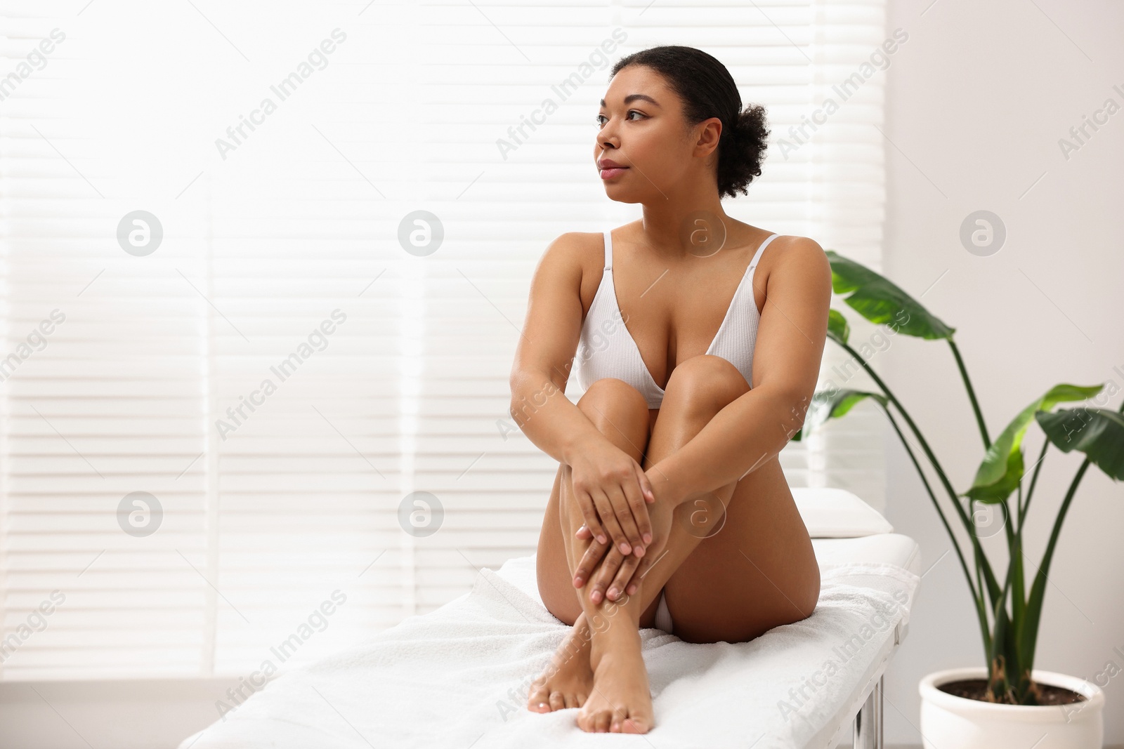 Woman in white underwear with smooth skin after epilation procedure in beauty salon, space for text Photo of Woman in white underwear with smooth skin after epilation procedure in beauty salon, space for text