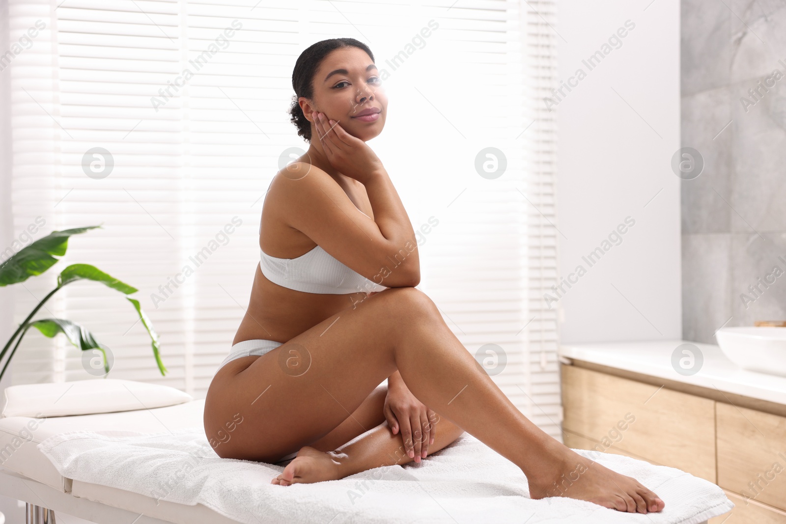 Photo of Woman in white underwear with smooth skin after epilation procedure in beauty salon