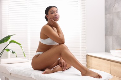 Photo of Woman in white underwear with smooth skin after epilation procedure in beauty salon