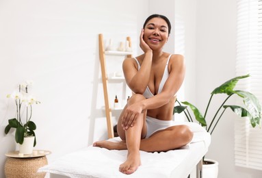 Photo of Woman in white underwear with smooth skin after epilation procedure in beauty salon