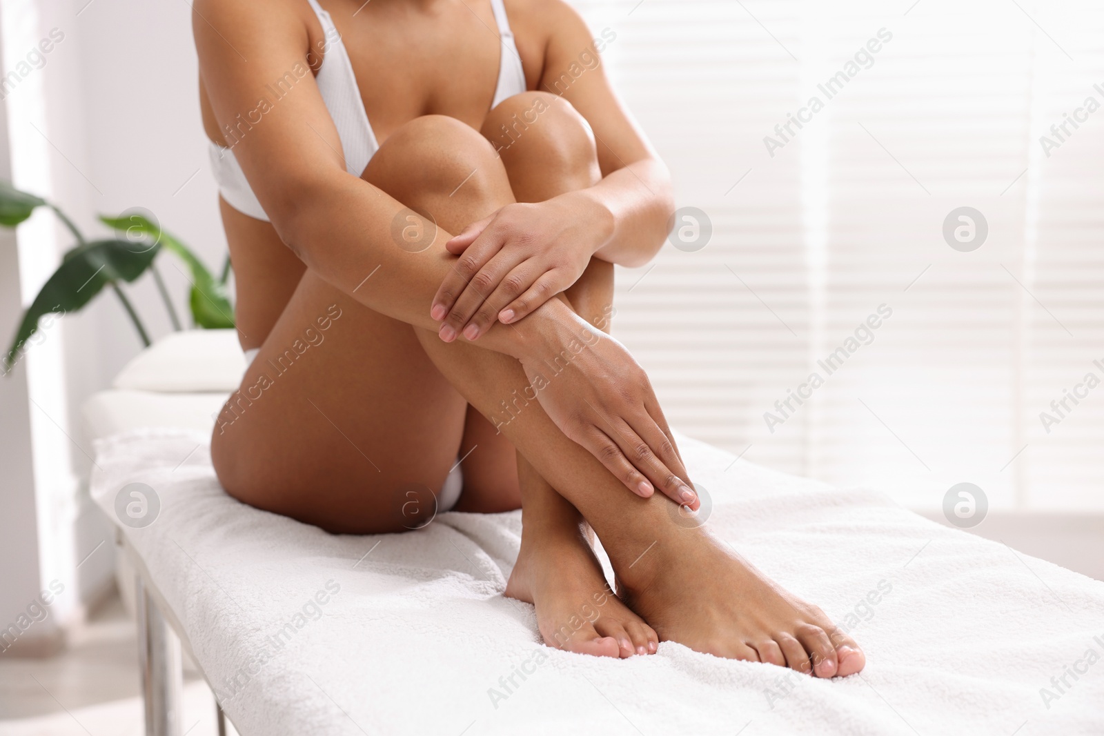 Photo of Woman in underwear with smooth skin after epilation procedure in beauty salon, closeup. Space for text