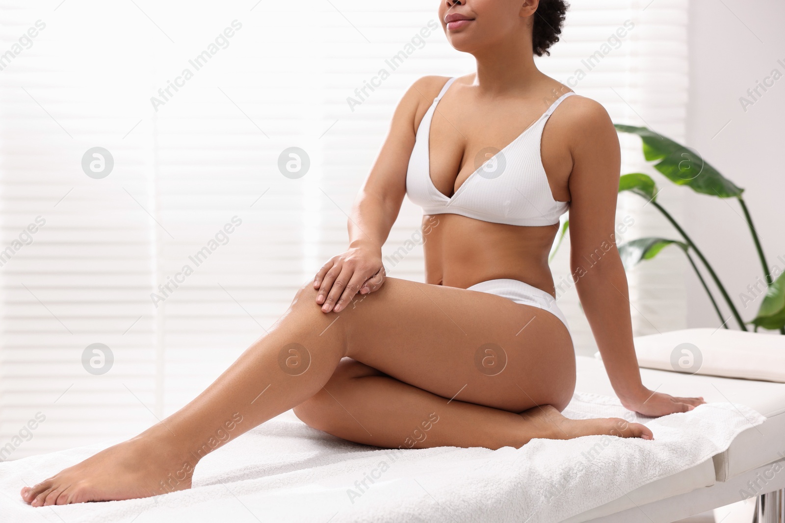 Photo of Woman in white underwear with smooth skin after epilation procedure in beauty salon, closeup