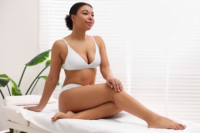 Photo of Woman in white underwear with smooth skin after epilation procedure in beauty salon