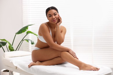 Photo of Woman in white underwear with smooth skin after epilation procedure in beauty salon