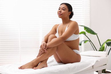 Photo of Woman in white underwear with smooth skin after epilation procedure in beauty salon