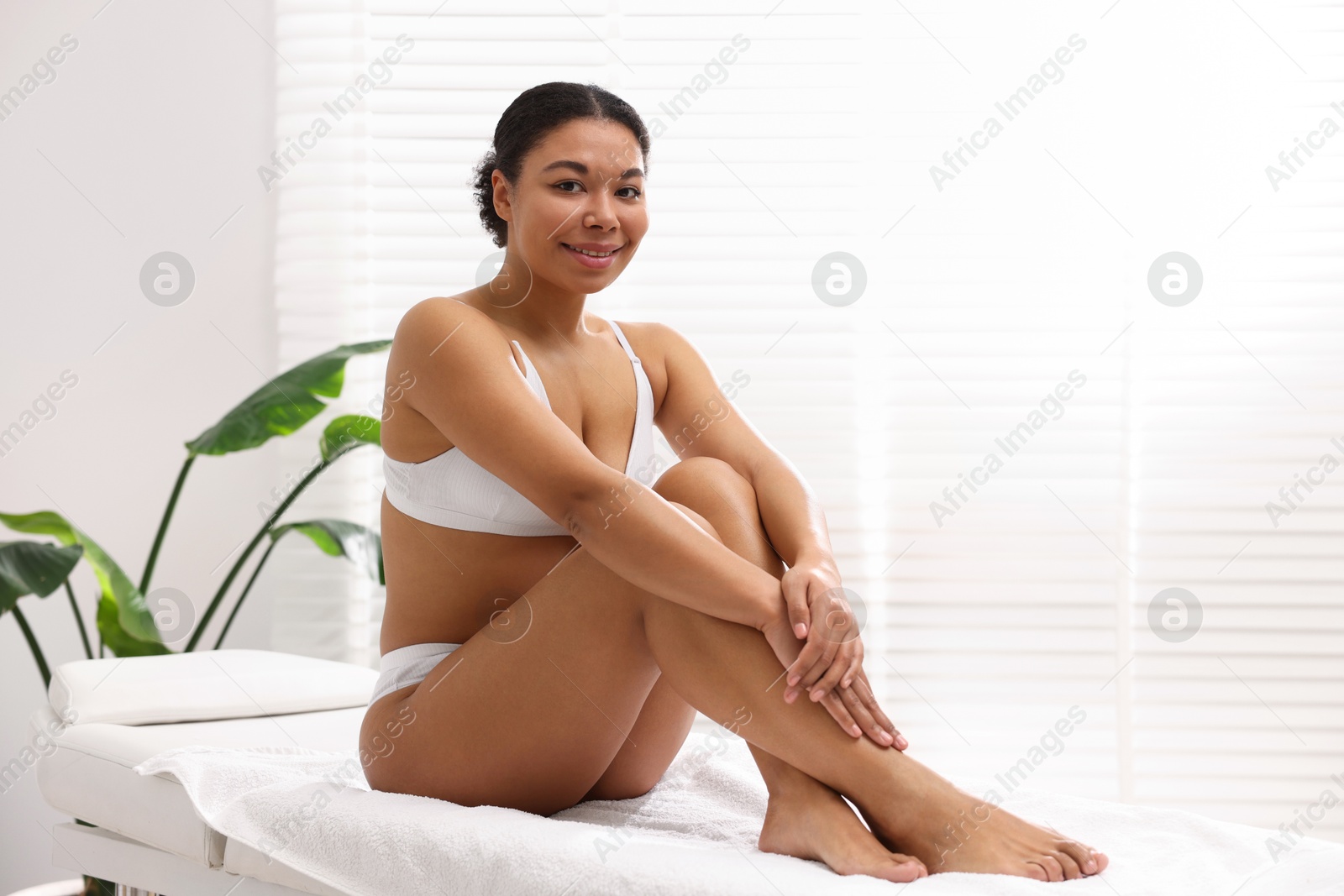 Woman in white underwear with smooth skin after epilation procedure in beauty salon Photo of Woman in white underwear with smooth skin after epilation procedure in beauty salon