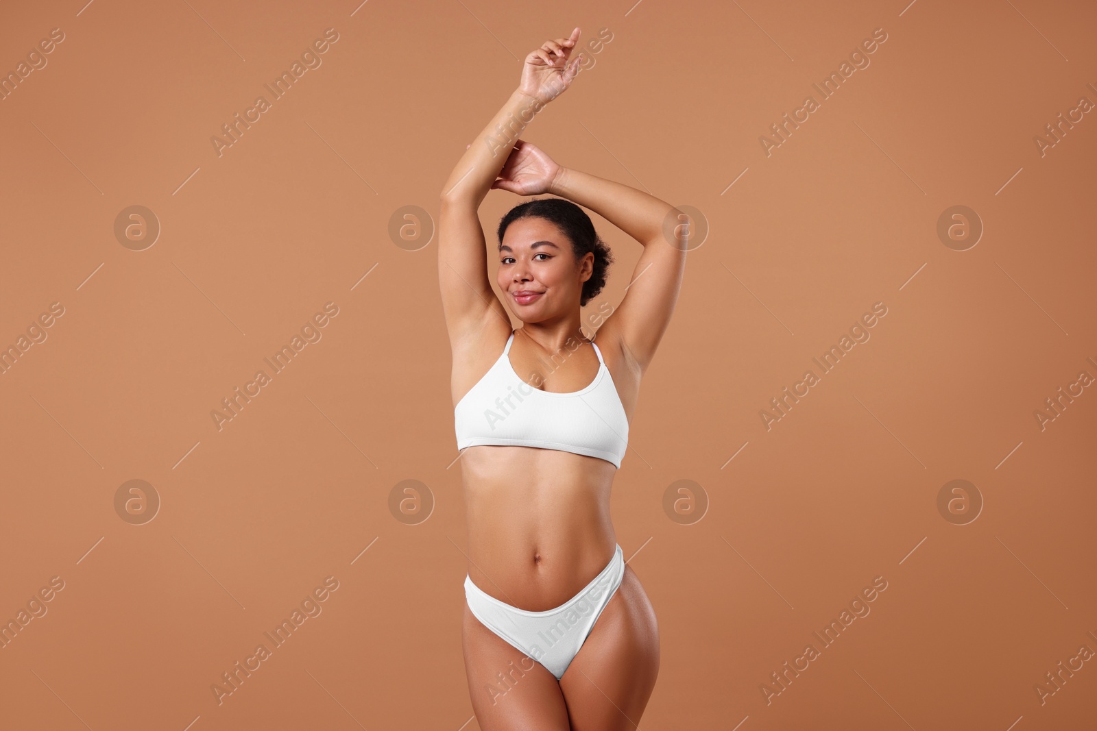 Photo of Woman in white underwear with smooth skin after epilation procedure on beige background