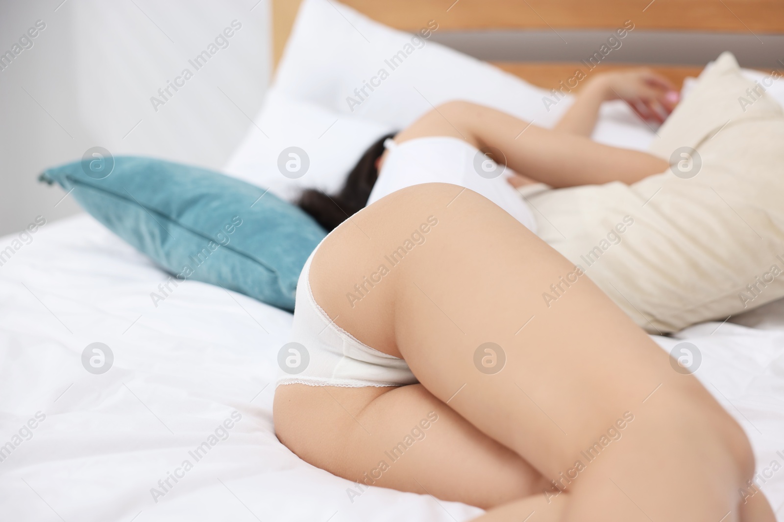 Woman in beautiful underwear lying on bed Photo of Woman in beautiful underwear lying on bed