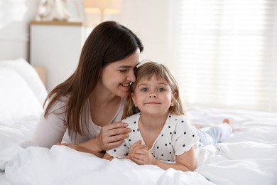Photo of Mother and daughter on bed at home