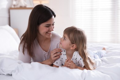 Photo of Mother and daughter on bed at home