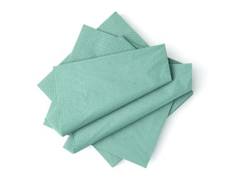 Photo of Many green paper handkerchiefs isolated on white, top view