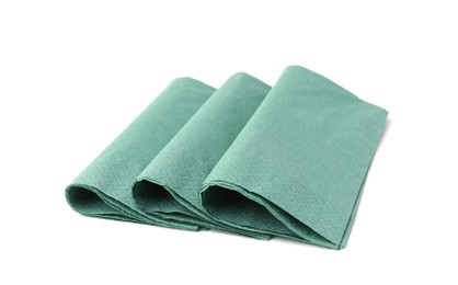 Photo of Many green paper handkerchiefs isolated on white