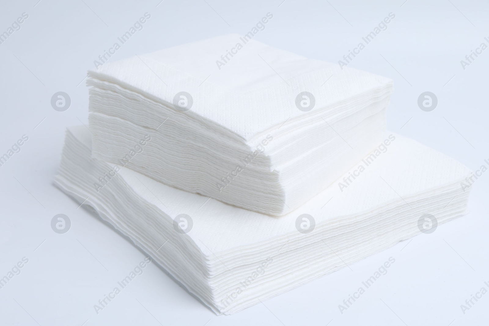Stack of disposable paper handkerchiefs isolated on white Photo of Stack of disposable paper handkerchiefs isolated on white