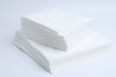Photo of Stack of disposable paper handkerchiefs isolated on white