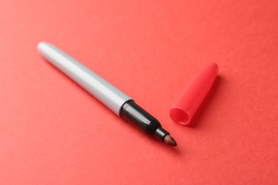 Photo of One color marker on red background, closeup