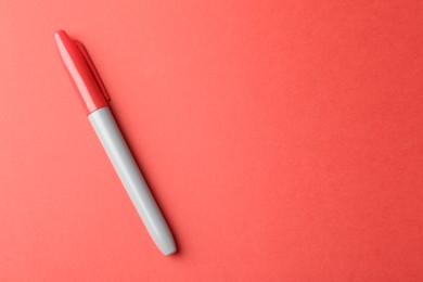 Photo of One color marker on red background, top view. Space for text