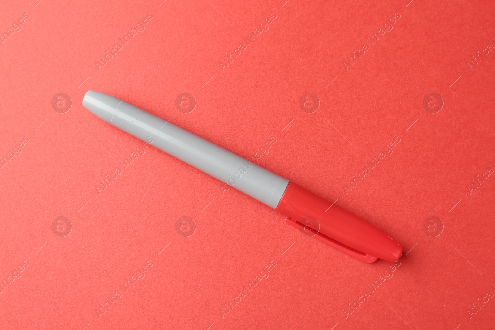 One color marker on red background, top view Photo of One color marker on red background, top view