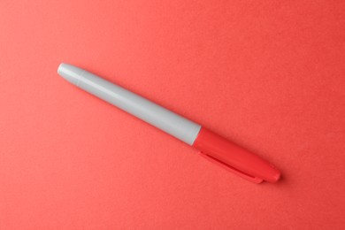 Photo of One color marker on red background, top view