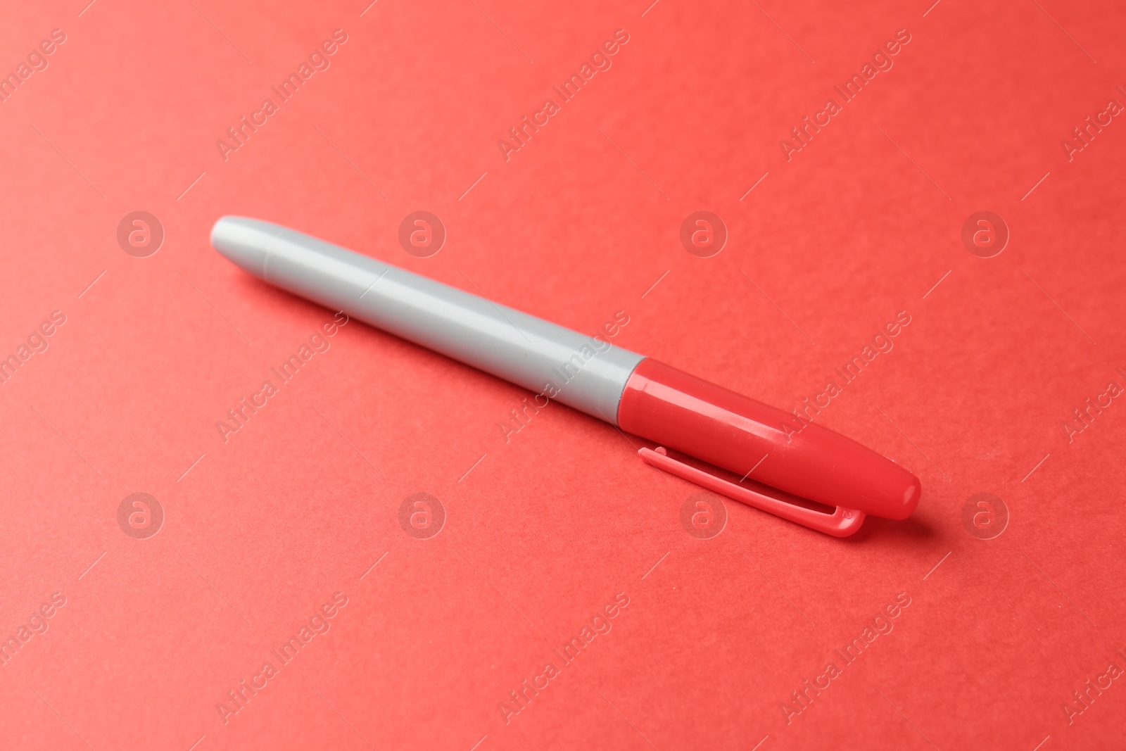 One color marker on red background, closeup Photo of One color marker on red background, closeup