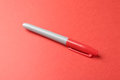 Photo of One color marker on red background, closeup