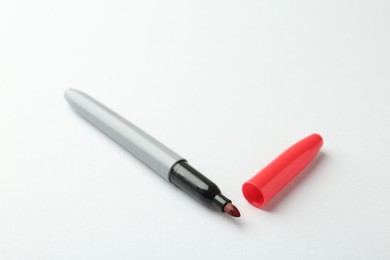 Photo of One red marker on light background, closeup. Space for text