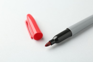 Photo of One red marker on light background, closeup