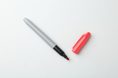 Photo of One red marker on light background, top view