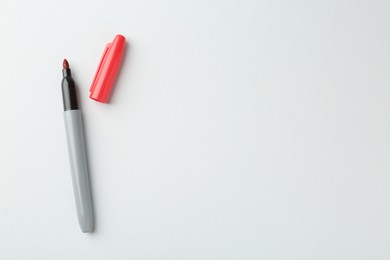 Photo of One red marker on light background, top view. Space for text