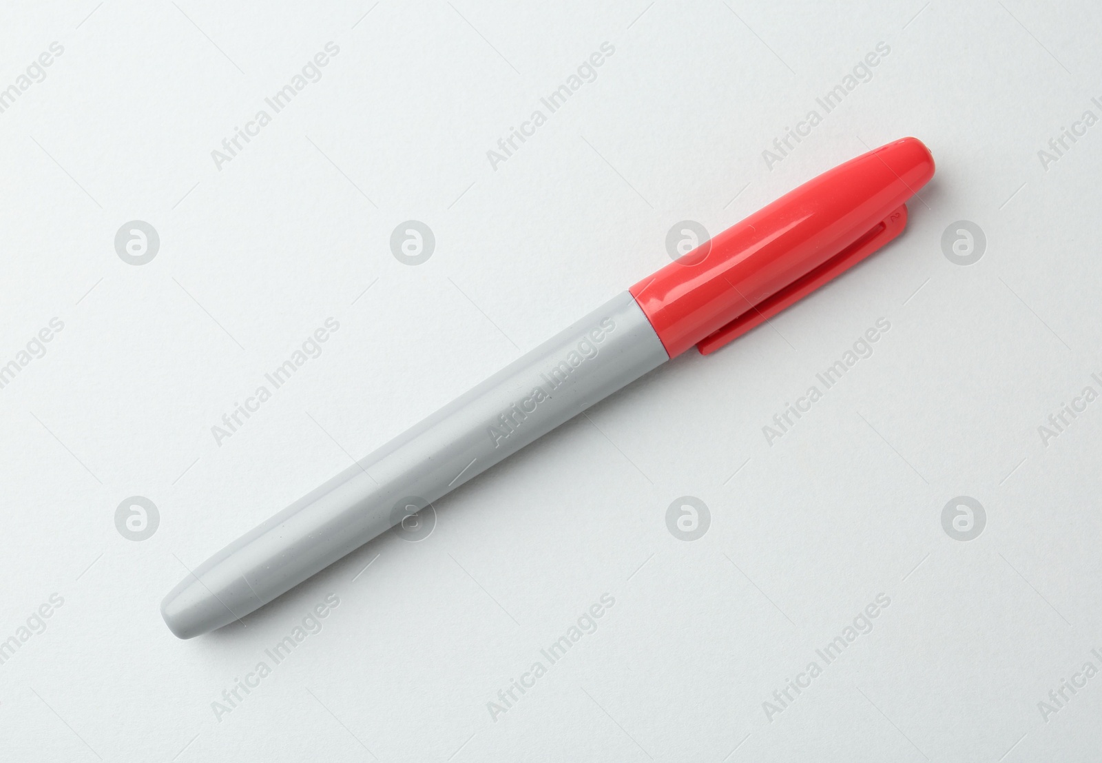 One red marker on light background, top view Photo of One red marker on light background, top view