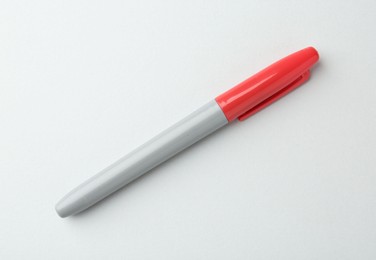 Photo of One red marker on light background, top view