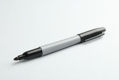 Photo of One black marker on light background. Space for text
