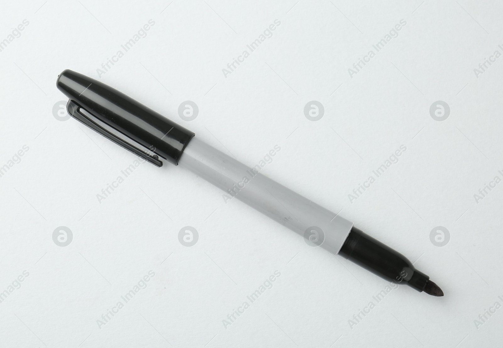 One black marker on light background, top view. Space for text Photo of One black marker on light background, top view. Space for text