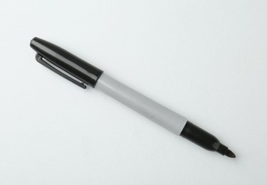Photo of One black marker on light background, top view. Space for text