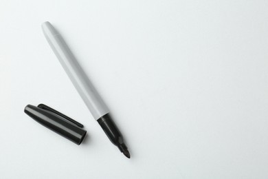 Photo of One black marker on light background, top view. Space for text
