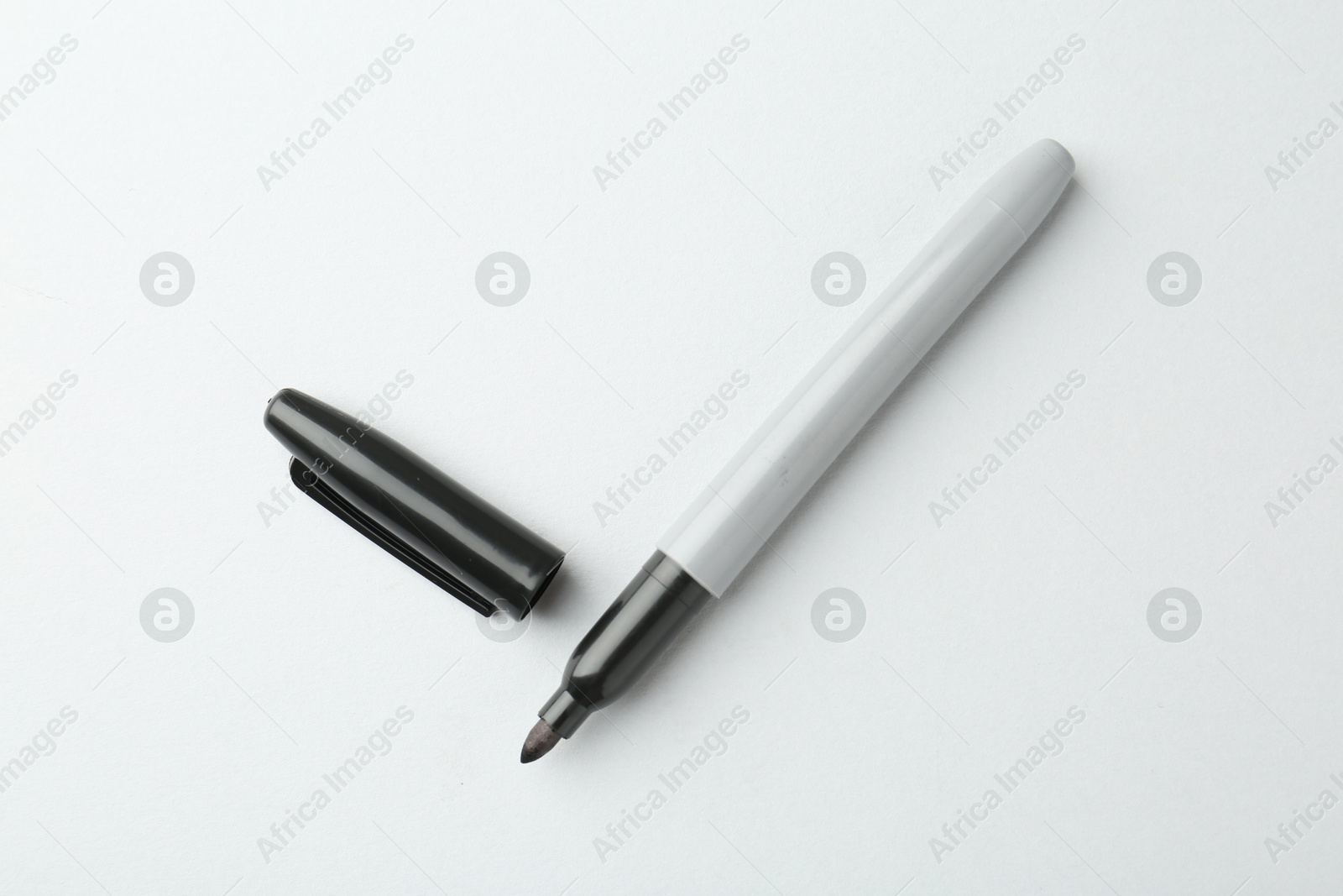 Photo of One black marker on light background, top view