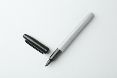 Photo of One black marker on light background, top view