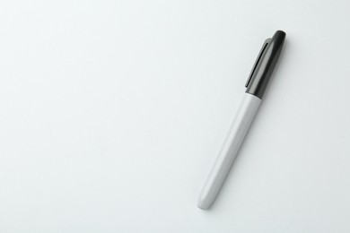 Photo of One black marker on light background, top view. Space for text