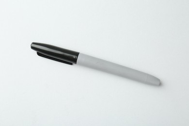 Photo of One black marker on light background, top view