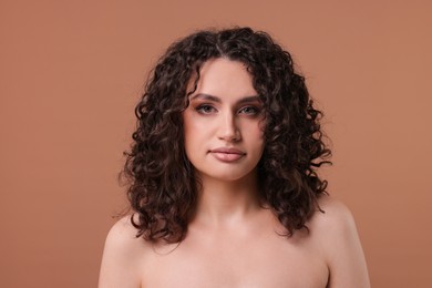 Photo of Portrait of beautiful woman on beige background