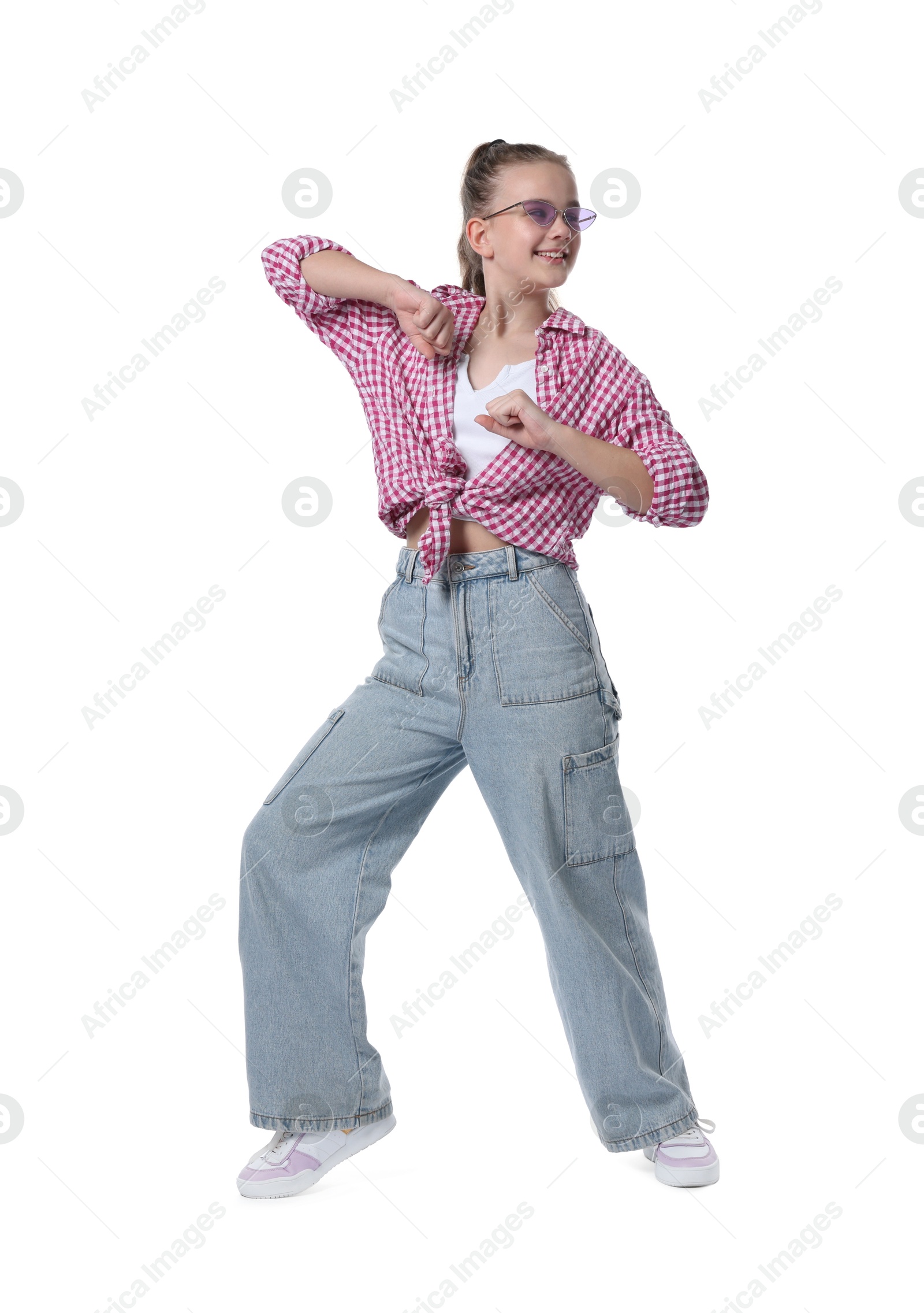 Girl in stylish clothes and sunglasses dancing on white background Photo of Girl in stylish clothes and sunglasses dancing on white background
