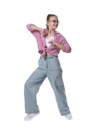 Photo of Girl in stylish clothes and sunglasses dancing on white background
